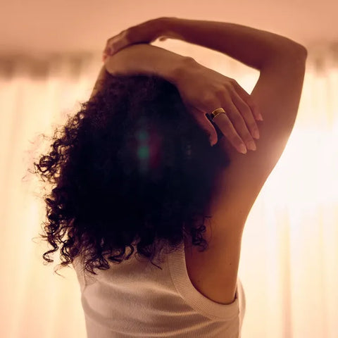 Person wearing a smart ring stretching arms in warm morning light | Smartring PH