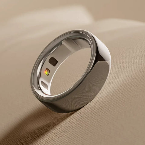 Close-up of a modern smart ring resting on a beige fabric surface | Smartphone PH